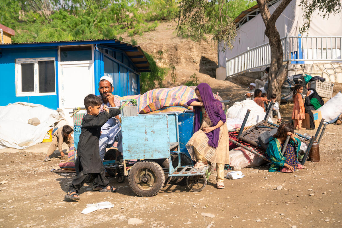 Gulab Shah, a returnee from Pakistan, sitting beside his belongings at the Torkham border, reflects a moment of quiet determination as he navigates the challenges of his return to Afghanistan with his family Afghanistan. Exhausted Afghan Families Return Through Torkham Border Amid Growing Challenges.