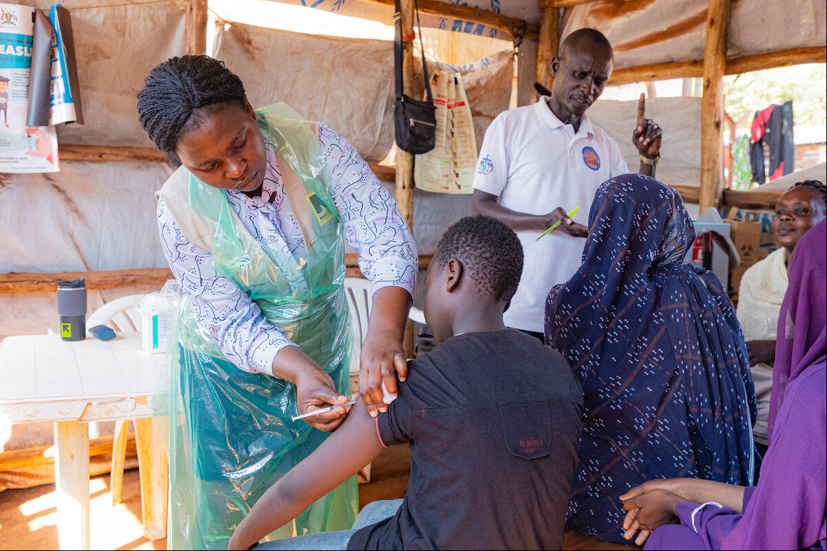 Refugees from Sudan are ed at the Kyriandongo reception center in Uganda. UNHCR and partners conduct health assessments, vaccinations, data collection and registration for newly arrived refugees from Sudan. Once this registration is complete, refugees are able to access additional services, including healthcare, education and the right to work. Uganda currently hosts the largest number of refugees in Africa – around 1.7 million people and welcomes more every day. As of July 2024, there were around 250 new arrivals from Sudan every day, and more than 30,000 people had come since the start of the year. Most having crossed multiple borders and traveled hundreds of miles on foot to find safety after fleeing war in Sudan. Refugees from Sudan are ed at Kyriandongo reception center in Uganda