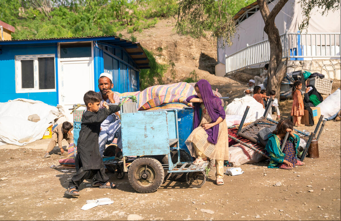 Gulab Shah, a returnee from Pakistan, sitting beside his belongings at the Torkham border, reflects a moment of quiet determination as he navigates the challenges of his return to Afghanistan with his family Afghanistan. Exhausted Afghan Families Return Through Torkham Border Amid Growing Challenges.