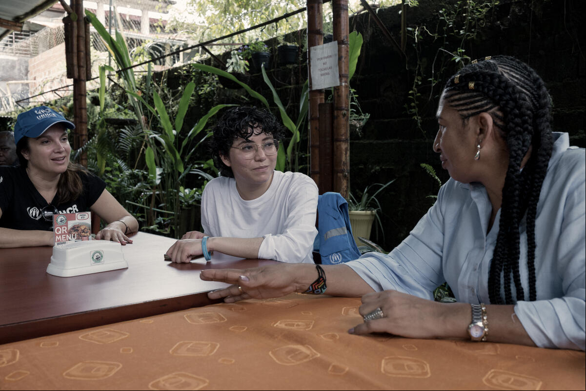 Human rights advocate and peace builder Elizabeth Moreno Barco, 55, who is the Americas Regional Winner of the 2023 UNHCR Nansen Refugee Award, speaks with UNHCR officers during a lunch break in Quibdó, Chocó Department, Colombia. After being forced to flee her home village of Togoromá in 2013, when the brutal reality of armed conflict between rival groups reached her community, Elizabeth, who is affectionately known as ‘Chava’, became determined to speak out against the violence and abuses taking place in Chocó. Since the mid-1980s, violence in Colombia has affected close to 10 million people, forcing more than 8 million from their homes. Chocó is one of the territories worst affected, with some 450,000 people killed as a result of armed conflict. Having already established herself as a local leader, Elizabeth became the first woman to be elected as the legal representative of ACADESAN, a territorial council that promotes and protects the rights of 72 Afro-Colombian communities living in the San Jua Colombia. UNHCR Nansen Refugee Award, 2023 Regional Winner for the Americas, Elizabeth Moreno Barco, defies danger to advocate for conflict-affected compatriots